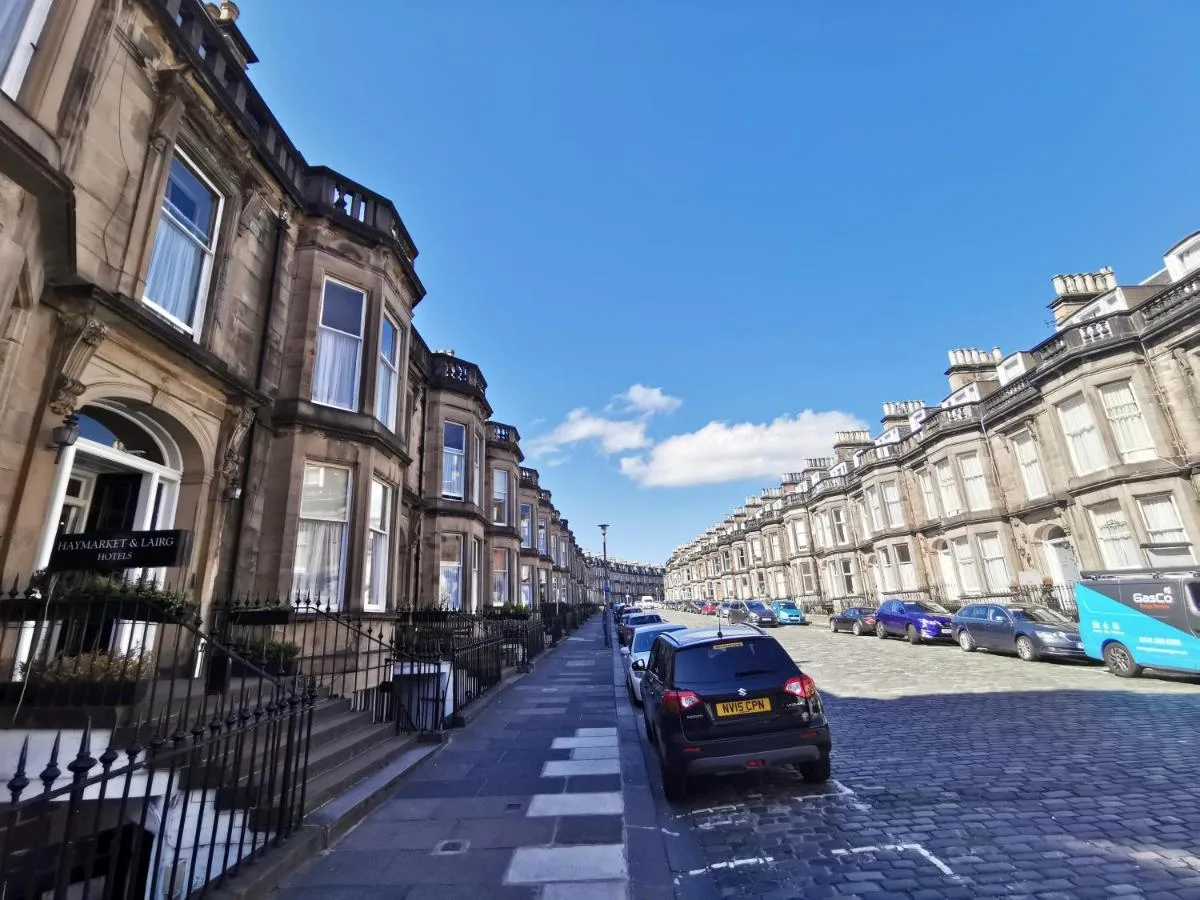 a street with houses and a car parked on the street at The Haymarket Hotel in Edinburgh